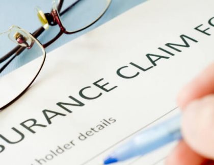 someone filling out an insurance claim form